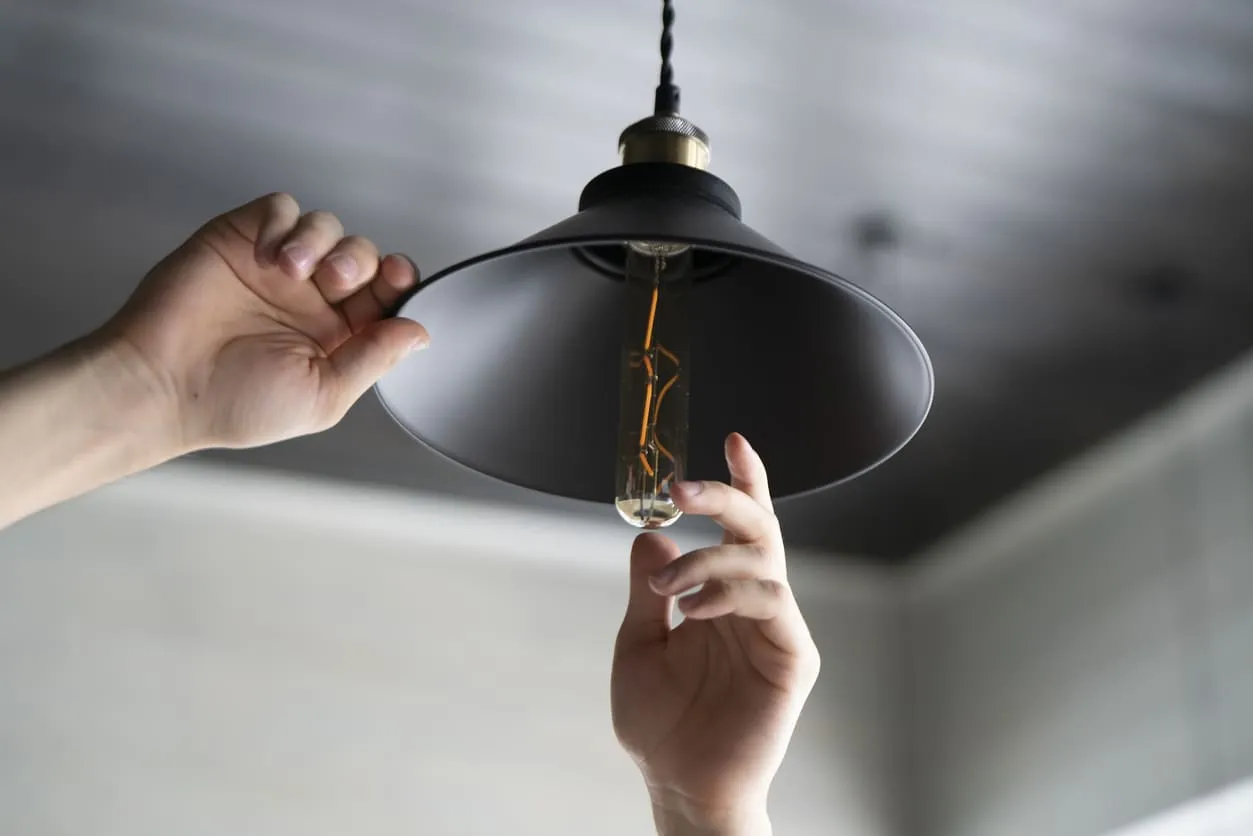 Hands and Ceiling Light Fixture